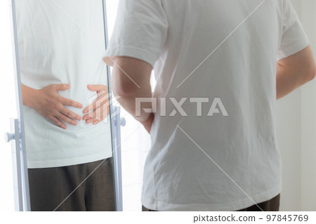 young man worried about his stomach young man worried about his stomach 97845769