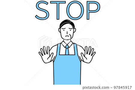 Sign of stop, senior man wearing an apron sticking out his hand in front of his body Sign of stop, senior man wearing an apron sticking out his hand in front of his body 97845917