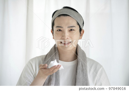 一個手上有洗面奶泡沫的年輕人洗臉護膚形象 97849016
