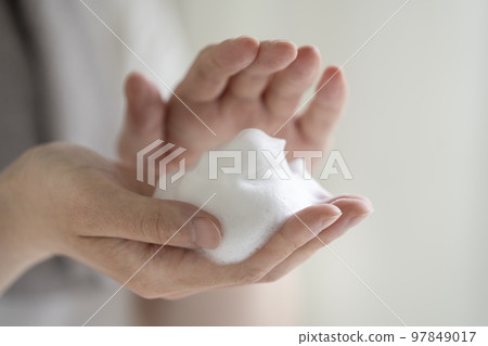 Young man's hand with soap bubbles Young man's hand with soap bubbles 97849017