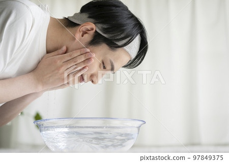 Young men washing face Young men washing face 97849375