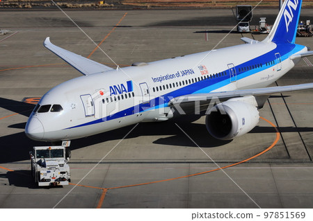 Airliner being towed by a towing tractor 97851569