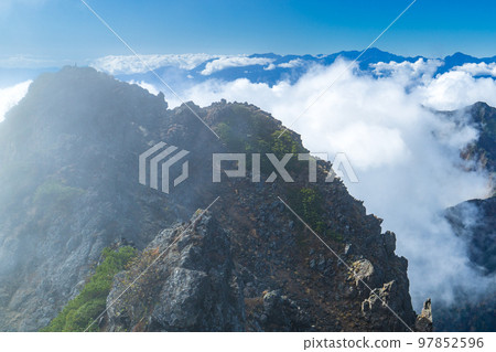 Climbing Yatsugatake in Nagano Prefecture: Ryuzu Peak and the Southern Alps in the Sea of Clouds seen from the summit of Mt. Akadake Climbing Yatsugatake in Nagano Prefecture: Ryuzu Peak and the Southern Alps in the Sea of Clouds seen from the summit of Mt. Akadake 97852596