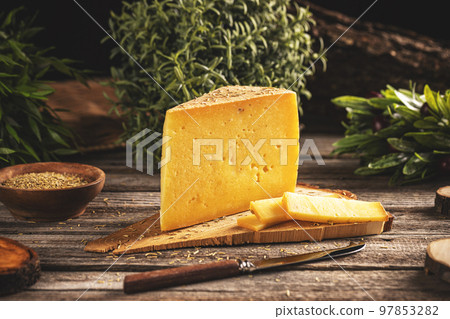 Triangle slices of cheese with rosemary Triangle slices of cheese with rosemary 97853282