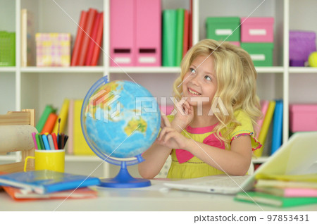 girl studying with a globe at the table 97853431