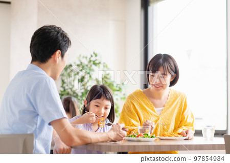Young family eating at a family restaurant 97854984