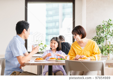 Young family eating at a family restaurant 97854989