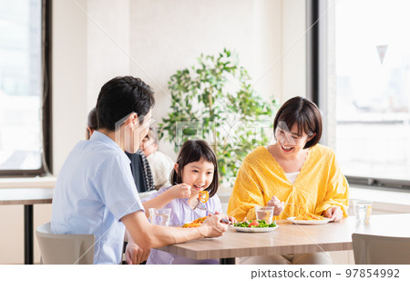 Young family eating at a family restaurant Young family eating at a family restaurant 97854992