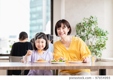 Young family eating at a family restaurant Young family eating at a family restaurant 97854993