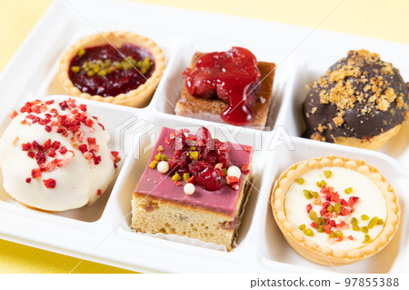 A set of delicious petit cakes and cream puffs 97855388
