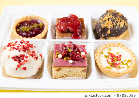 A set of delicious petit cakes and cream puffs 97855389
