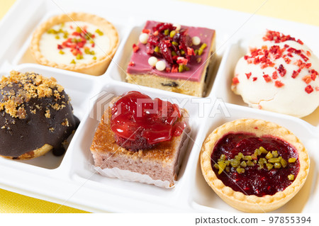 A set of delicious petit cakes and cream puffs A set of delicious petit cakes and cream puffs 97855394