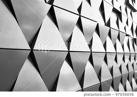 Silver wall facade with geometric shapes triangle elements. Abstract architecture details pattern. Minimal abstract background Silver wall facade with geometric shapes triangle elements. Abstract architecture details pattern. Minimal abstract background 97856056
