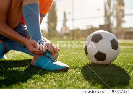 Soccer ball on grass and children football team training 97857351