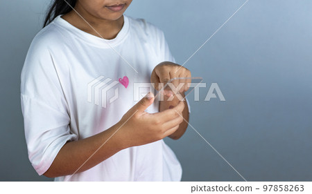 woman holding a blank screen phone mockup transparent acrylic used for displaying text or advertising images. 97858263