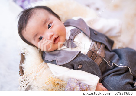 A 3-month-old baby with a cute smile in a tuxedo A 3-month-old baby with a cute smile in a tuxedo 97858696