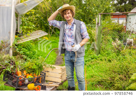 Contented agriculturist working on an organic farm 97858746