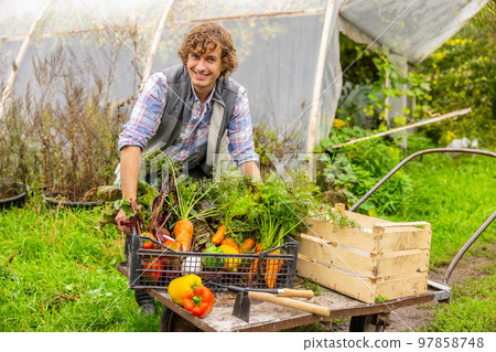 Contented young agriculturist working in the countryside 97858748