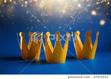 Happy Epiphany Day, Three Kings Day greeting card with three gold crowns on blue background. Concept for Dia de Reyes Magos day, three Wise Men, Epiphany Christian feast day Happy Epiphany Day, Three Kings Day greeting card with three gold crowns on blue background. Concept for Dia de Reyes Magos day, three Wise Men, Epiphany Christian feast day 97858835