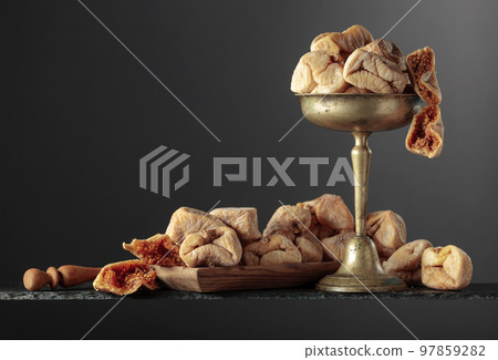 Dried figs on a black background. 97859282