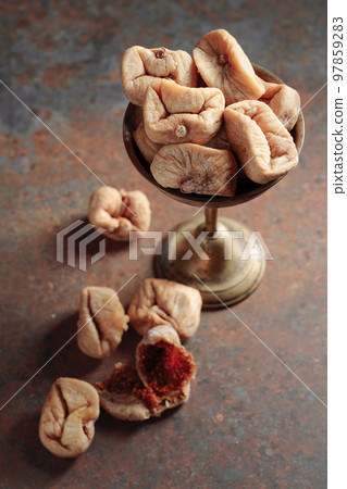 Dried figs in an old brass dish. Dried figs in an old brass dish. 97859283