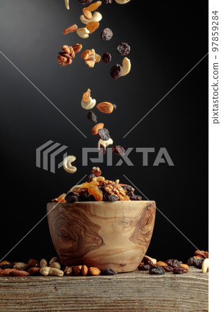 Flying dried fruits and nuts. 97859284