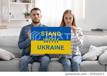 Patriotic Young Couple Holding Poster With Stand With Ukraine Inscription 97859423