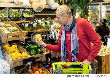 Smiling male pensioner buying food at supermarket, copy space 97859445