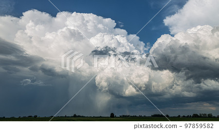Storm clouds over field, tornadic supercell, extreme weather, dangerous storm Storm clouds over field, tornadic supercell, extreme weather, dangerous storm 97859582