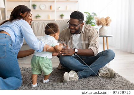 Black baby toddler walking in living room making first steps 97859735