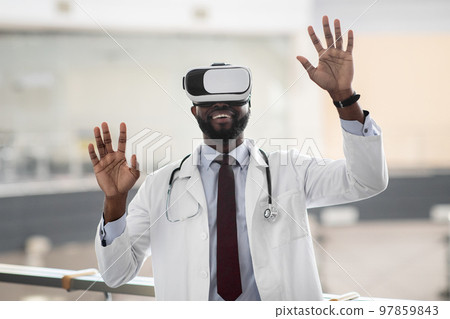 Excited african american doctor testing modern technologies in healtchare Excited african american doctor testing modern technologies in healtchare 97859843
