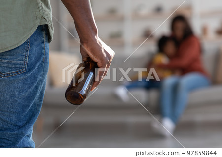 Black Man Holding Bottle Of Alcohol And Threatening Wife And Little Daughter 97859844
