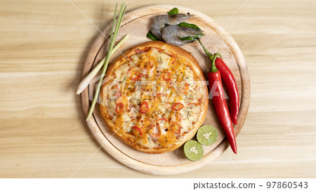 Tom Yum Pizza made by Thailand, Ingredients of Tom Yum Kung are the original curry paste, Lemongrass, Kaffir lime leaves and lime. Promotional poster for restaurant or pizza sale, Text space. 97860543