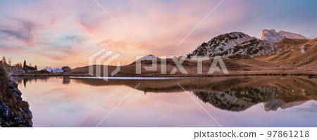 Early morning autumn alpine Dolomites mountain scene. Peaceful Valparola Path and Lake view, Belluno, Italy. Early morning autumn alpine Dolomites mountain scene. Peaceful Valparola Path and Lake view, Belluno, Italy. 97861218