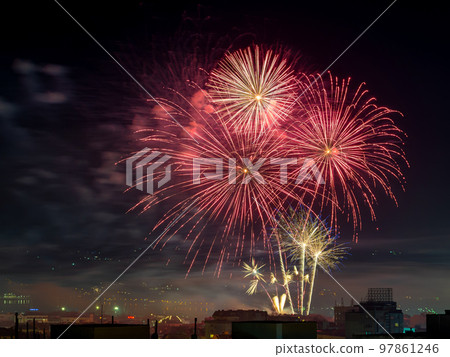 Red firework bursts and sparks in the dark sky. Red firework bursts and sparks in the dark sky. 97861246