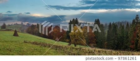 Cloudy and foggy autumn mountains scene. Peaceful picturesque traveling, seasonal, nature and countryside beauty concept scene. Carpathian Mountains, Ukraine. 97861261