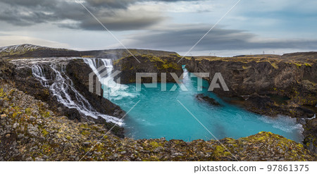 Picturesque waterfall Sigoldufoss autumn view. Season changing in southern Highlands of Iceland. 97861375