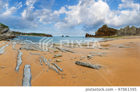 Beautiful sandy Playa Del Portio (Biskaya, Cantabria, Spain) summer landscape. Atlantic Ocean coastline view with rock formations. 97861395