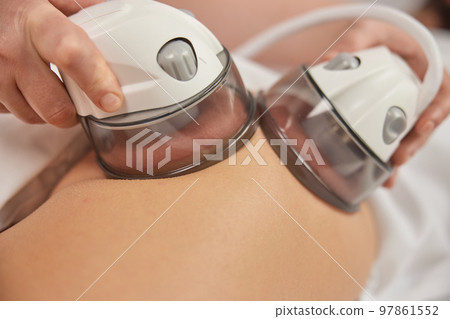 professional equipment, receiving massage, Applying vacuum. Massage of body with vacuum, problem areas slimming using professional equipment, lpg massage, anti-cellulite roller-vacuum massages professional equipment, receiving massage, Applying vacuum. Massage of body with vacuum, problem areas slimming using professional equipment, lpg massage, anti-cellulite roller-vacuum massages 97861552