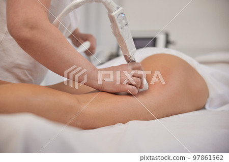 anti cellulite massage, Fighting overweight, lymphatic drainage. Young woman from beauty salon performs beauty services, body shaping, masseurs perform vacuum roller massages for clients, correcting anti cellulite massage, Fighting overweight, lymphatic drainage. Young woman from beauty salon performs beauty services, body shaping, masseurs perform vacuum roller massages for clients, correcting 97861562