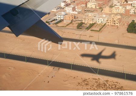 Shadow of a plain landing in Sharm El Sheikh, Egypt Shadow of a plain landing in Sharm El Sheikh, Egypt 97861576