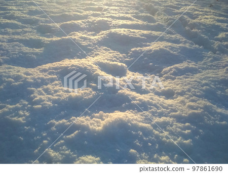 White snow surface background - top view of fresh snow texture on the ground White snow surface background - top view of fresh snow texture on the ground 97861690