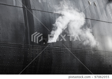 White steam goes out of black ship hull, abstract photo 97862055