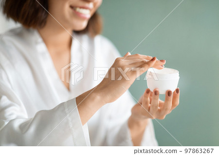 Cropped of young woman using face cream at home Cropped of young woman using face cream at home 97863267