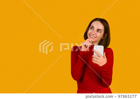 Excited brunette woman checking newest mobile app, using phone 97863277