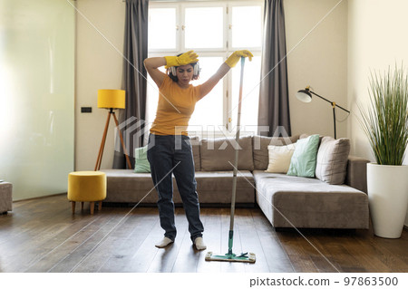 Young Arab Woman Feeling Tired While Making Cleaning In Living Room 97863500