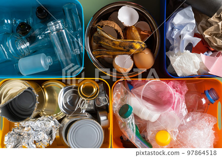 Multicolored plastic containers filling with different sort of waste and rubbish, like organic food, paper, plastic, tin Multicolored plastic containers filling with different sort of waste and rubbish, like organic food, paper, plastic, tin 97864518