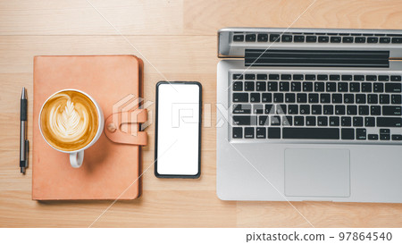 Office desk workspace with blank screen smart phone, laptop computer, notebook, pen and cup of coffee, Top view flat lay with copy space. 97864540