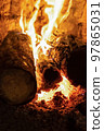 fireplace with burning wood close-up, fire burns in the stove 97865031