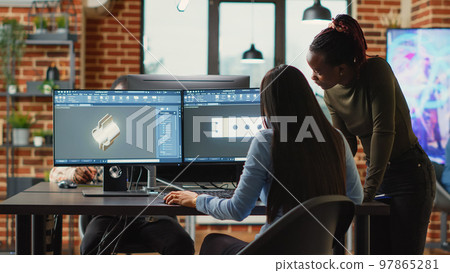 Diverse engineers colleagues brainstorming ideas to develop clamp product, doing teamwork to create mechanical prototype with cad software. Young technicians working in manufacturing industry. Diverse engineers colleagues brainstorming ideas to develop clamp product, doing teamwork to create mechanical prototype with cad software. Young technicians working in manufacturing industry. 97865281